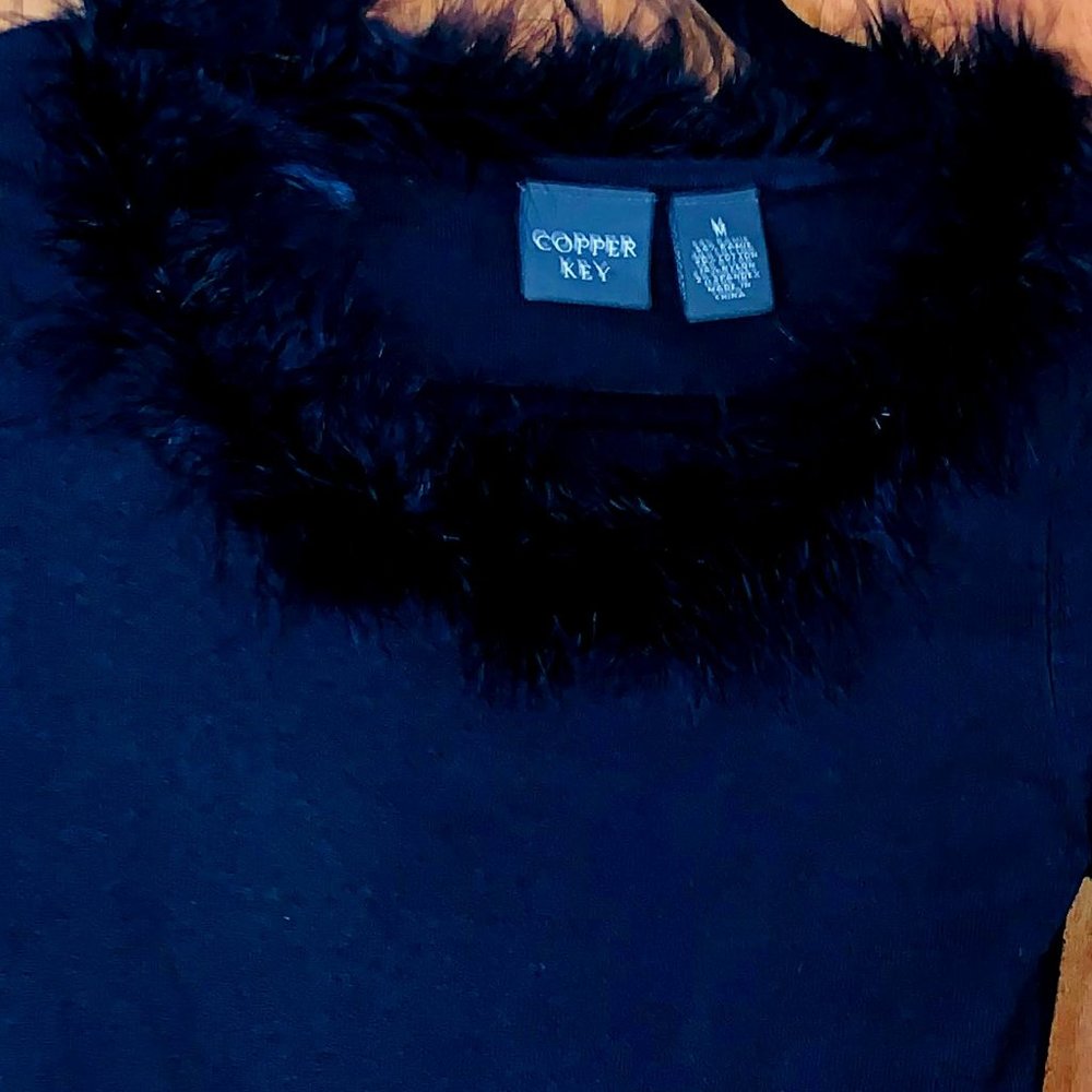 Slightly used  Copper Key Black sweater with faux feather trim.  Size Medium